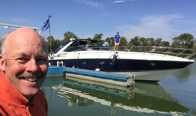 A person standing in front of a boat

Description automatically generated
