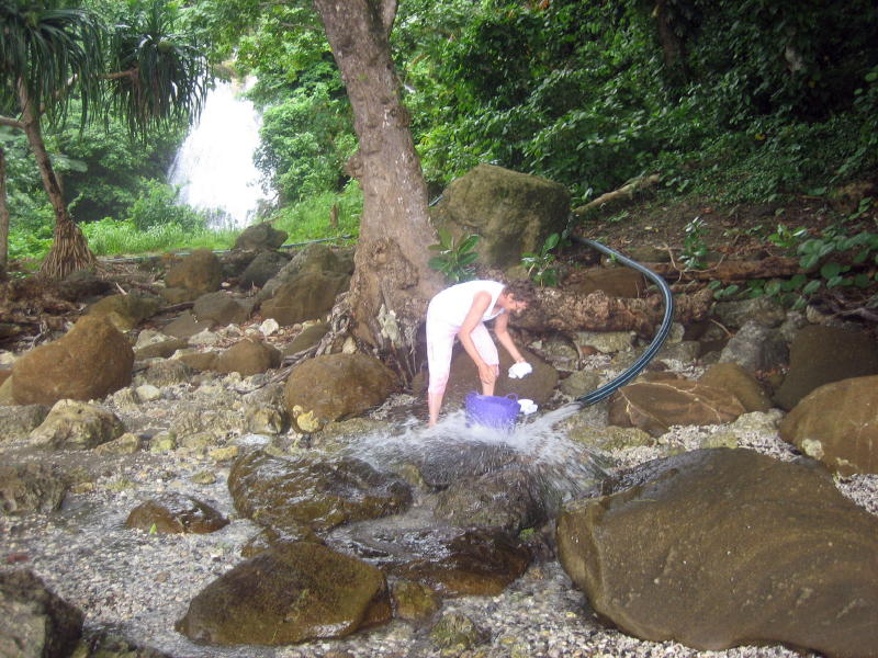 Rining the washing at the waterfall.