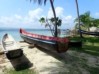 A boat sitting on top of a sandy beach

Description automatically generated