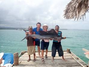 A group of people standing next to a body of water

Description automatically generated