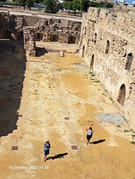 A person and child standing in an old courtyard

Description automatically generated with medium confidence