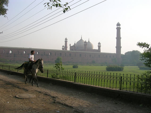 Riding alongside the Great Mogul Badshahi mosque with the setting sun.