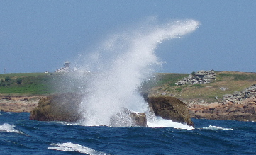 Breaking wave over rock